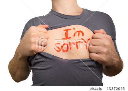 Man tearing apart grey t-shirt. Red text I am sorry written on h 13870046