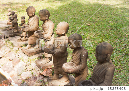 Little monk clay doll decorated in garden Little monk clay doll decorated in garden 13873498