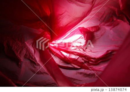 Abstract background of the insides of a red plastic bag with different color shades Abstract background of the insides of a red plastic bag with different color shades 13874074