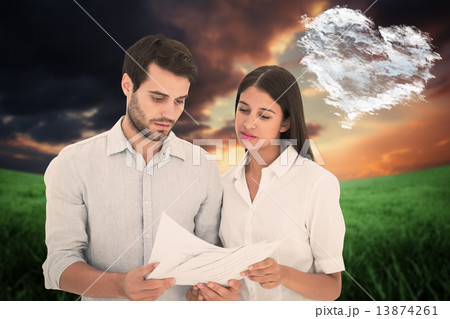 Composite image of attractive young couple reading their bills 13874261