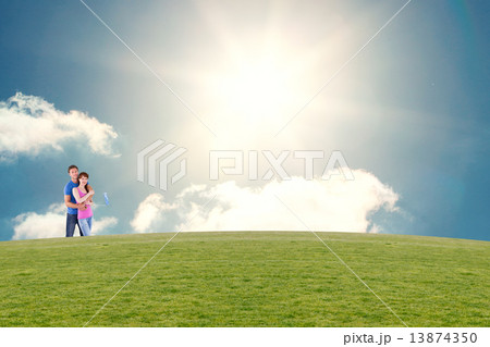 Composite image of couple hugging and holding brush Composite image of couple hugging and holding brush 13874350
