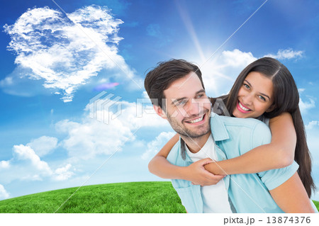 Composite image of happy casual man giving pretty girlfriend pig 13874376