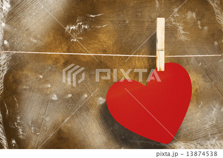 Composite image of heart hanging on line 13874538