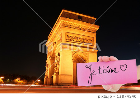 Composite image of hand holding card showing je taime 13874540