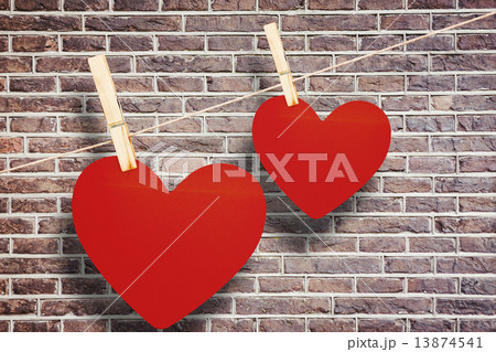 Composite image of hearts hanging on a line 13874541