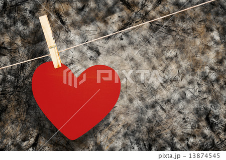 Composite image of heart hanging on line 13874545