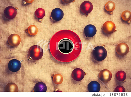 Hot coffee and christmas balls on jute background. 13875638
