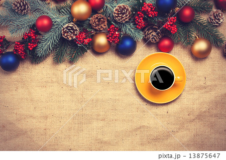 Hot coffee with christmas tree shape on a table near pine branch Hot coffee with christmas tree shape on a table near pine branch 13875647