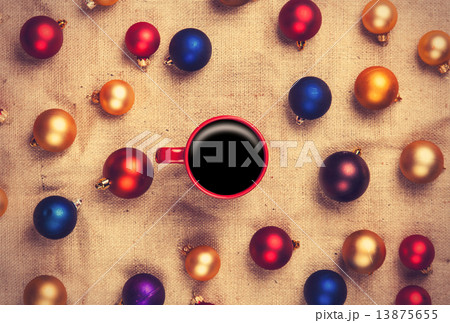 Hot coffee and christmas balls on jute background. Hot coffee and christmas balls on jute background. 13875655