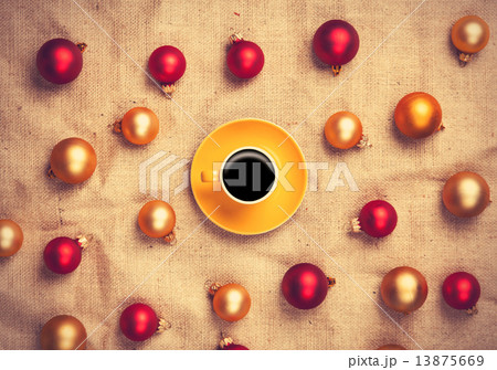Hot coffee and christmas balls on jute background. Hot coffee and christmas balls on jute background. 13875669