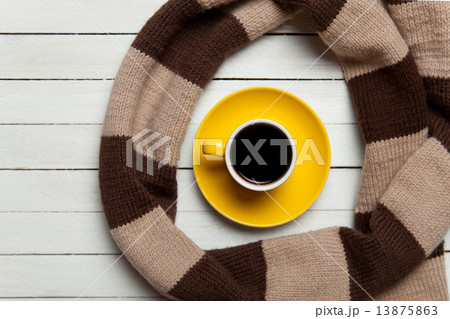 Cup of coffee and scarf on wooden table. Cup of coffee and scarf on wooden table. 13875863