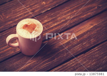 Cup of coffee with shape heart on wooden table. Cup of coffee with shape heart on wooden table. 13875981