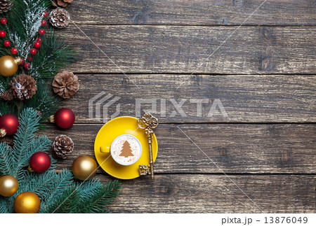 Cappuccino with christmas tree shape and pine branch on wooden t 13876049