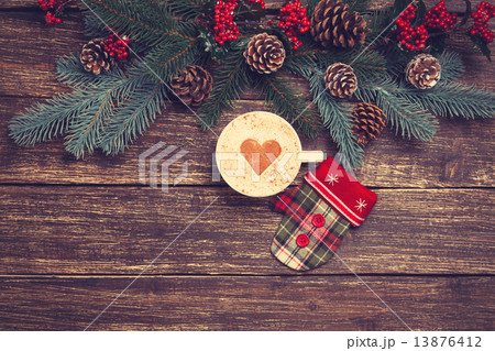 Hot cappuccino on wooden table near pine branches 13876412