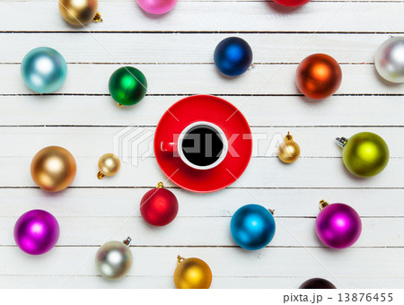Coffee cup and christmas balls on white background. Coffee cup and christmas balls on white background. 13876455