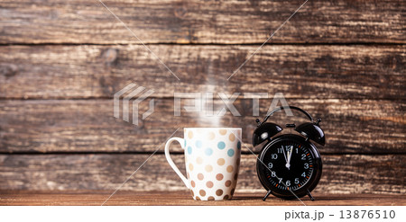 Tea or coffee cup and alarm clock Tea or coffee cup and alarm clock 13876510
