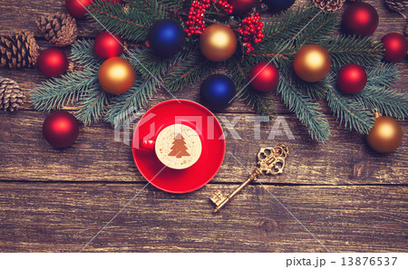 Hot cappuccino with christmas tree shape on a wooden table near 13876537