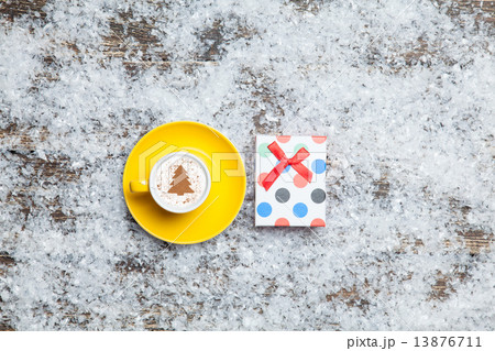 Cappuccino with christmas tree shape and gift box on artificial Cappuccino with christmas tree shape and gift box on artificial 13876711