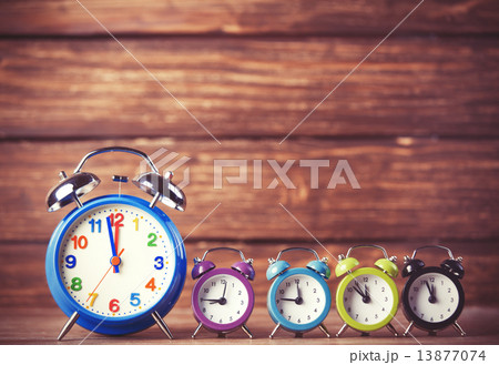 Retro alarm clocks on a table. Photo in retro color image style 13877074