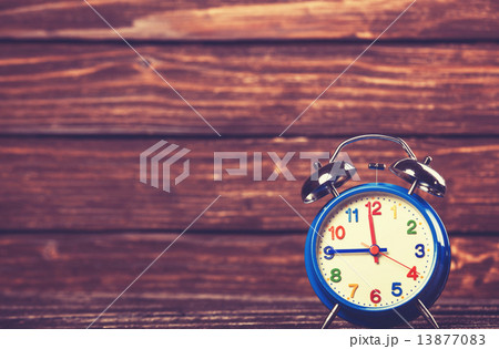 Retro alarm clock on a table. Photo in retro color image style Retro alarm clock on a table. Photo in retro color image style 13877083