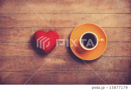 Cup of coffee and shape heart on a wooden table. 13877179