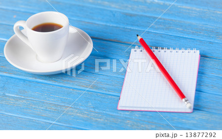 Cup of coffee and notebook. Cup of coffee and notebook. 13877292