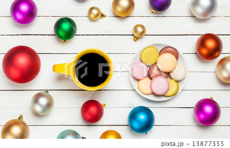 Cup of coffee and macaron with christmas toys on whte background Cup of coffee and macaron with christmas toys on whte background 13877355