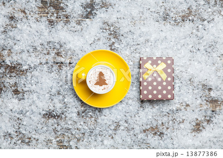 Cappuccino with christmas tree shape and gift box on artificial 13877386