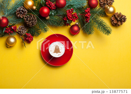 cappuccino and christmas tree shape and pine branch on yellow ba cappuccino and christmas tree shape and pine branch on yellow ba 13877571