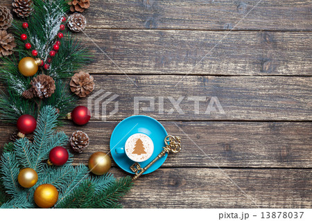 Cappuccino with christmas tree shape and pine branch on wooden t 13878037
