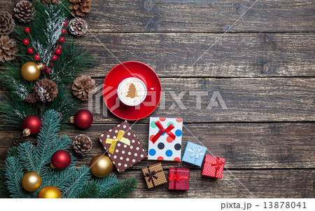Cappuccino with christmas tree shape and gifts on wooden table. 13878041