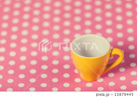 Cup of a coffe on polka dot cover 13879445