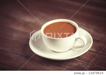 Cup of coffee on wooden table. Cup of coffee on wooden table. 13879624