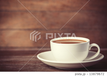Cup of coffee on wooden table. Cup of coffee on wooden table. 13879672