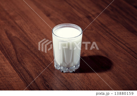 Glass of milk on wooden table on white background 13880159