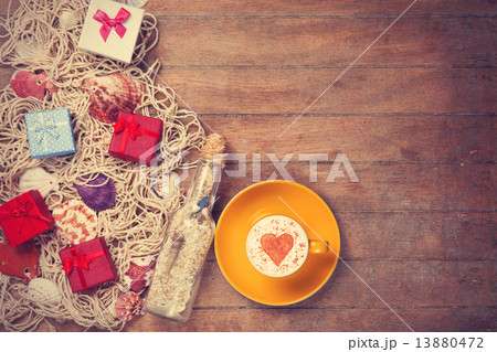 Cup, gift and net with shells and bottle 13880472