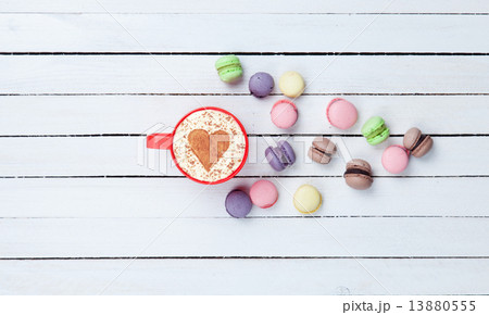 Cappuccino with heart shape symbol and macaron Cappuccino with heart shape symbol and macaron 13880555