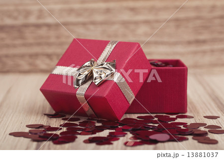 Red hearts confetti on wooden background 13881037