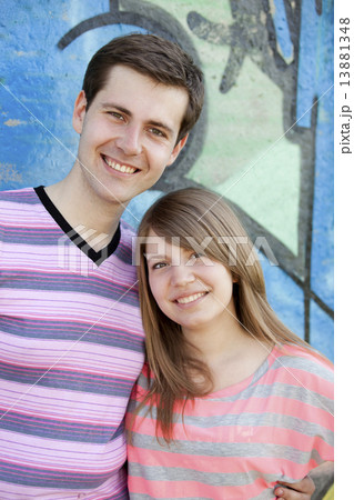 Young couple near graffiti background. 13881348
