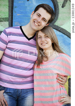 Young couple near graffiti background. 13881349