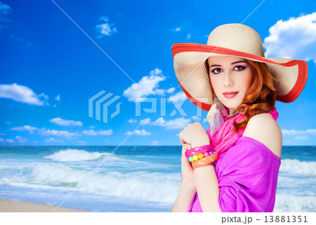 Redhead girl on the beach. 13881351