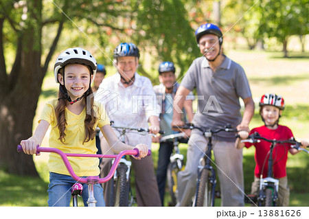 Happy family on their bike at the park Happy family on their bike at the park 13881626
