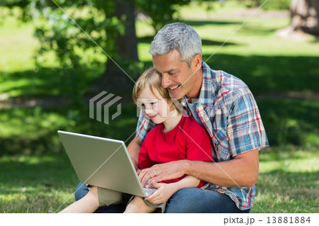 Happy father using laptop with his son Happy father using laptop with his son 13881884