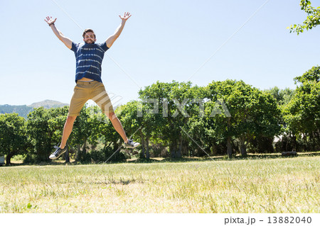 Handsome hipster feeling free in the park Handsome hipster feeling free in the park 13882040