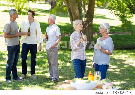 Happy family drinking in the park Happy family drinking in the park 13882218