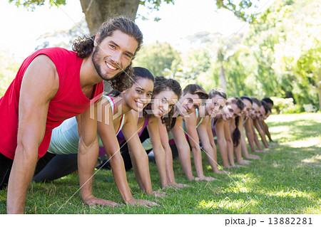 Fitness group planking in park Fitness group planking in park 13882281