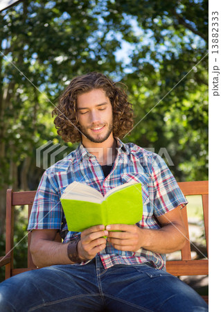 Young man reading in the park 13882333