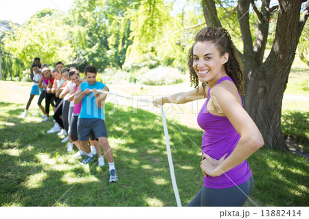 Fitness group playing tug of war 13882414
