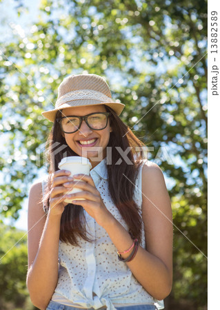 Pretty brunette having coffee to go Pretty brunette having coffee to go 13882589