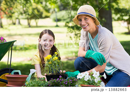 Happy blonde and her daughter gardening Happy blonde and her daughter gardening 13882663